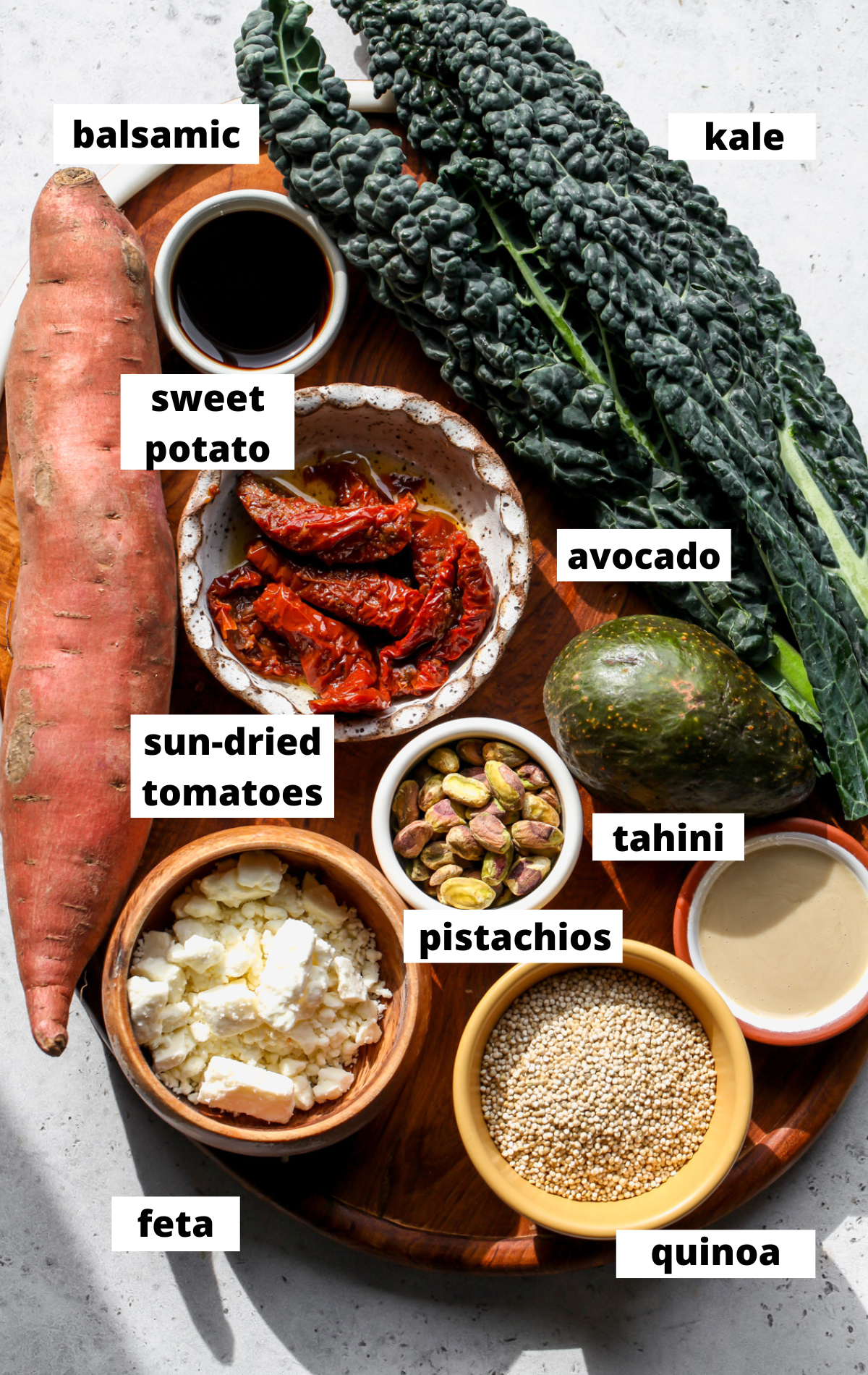 Recipe ingredients arranged on a wooden platter with labels.