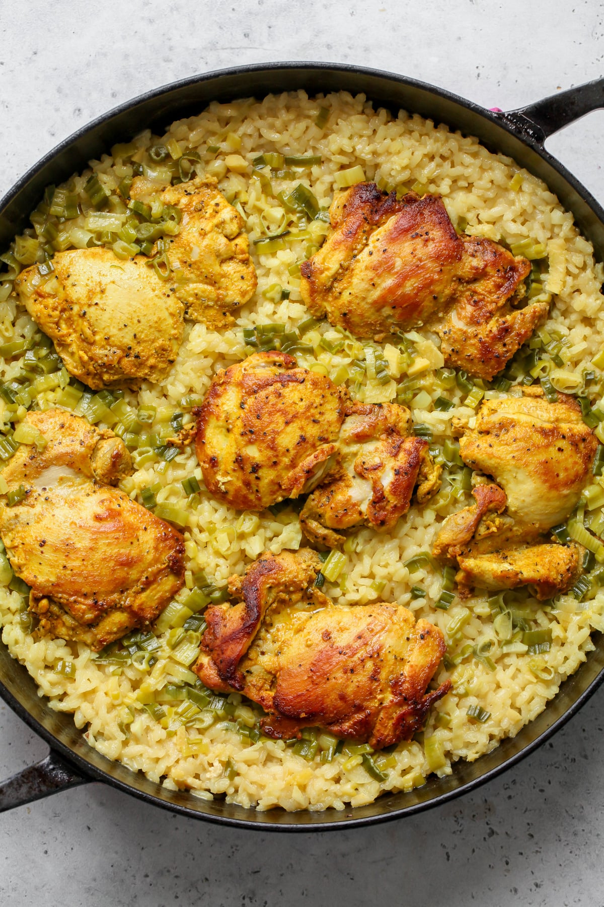 Skillet of chicken and rice after being baked.