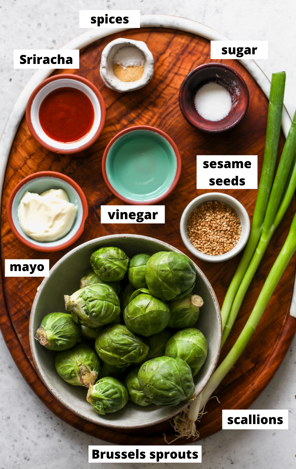 Recipe ingredients arranged on a wooden board with labels.