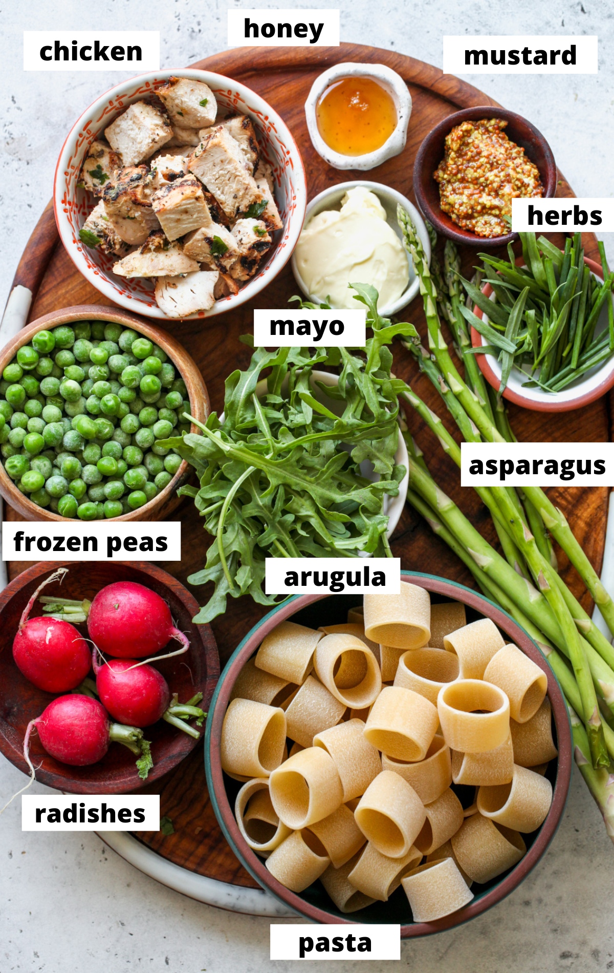 Recipe ingredients in separate bowls arranged on a wooden board.