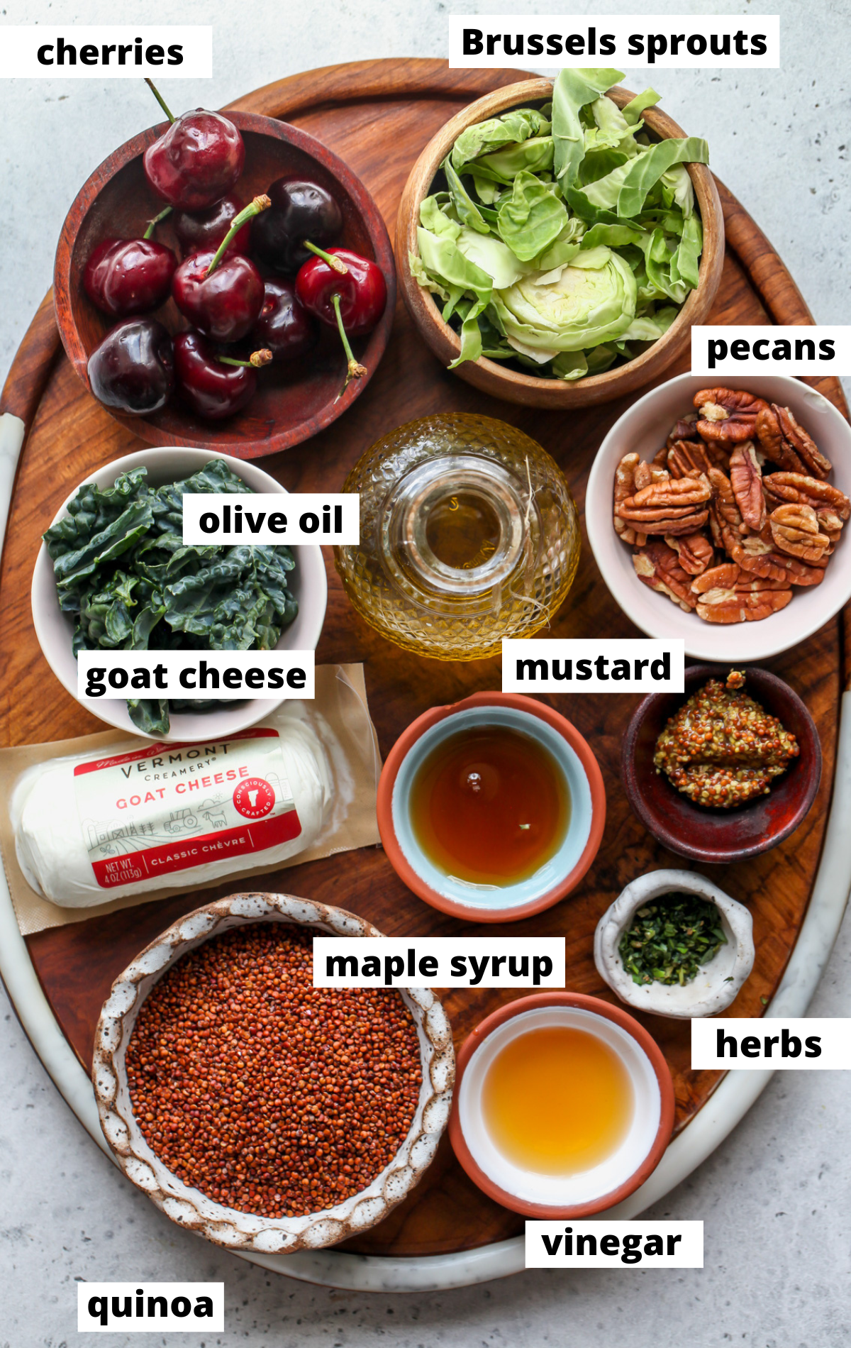 Recipe ingredients in separate bowls with labels on a wooden platter.