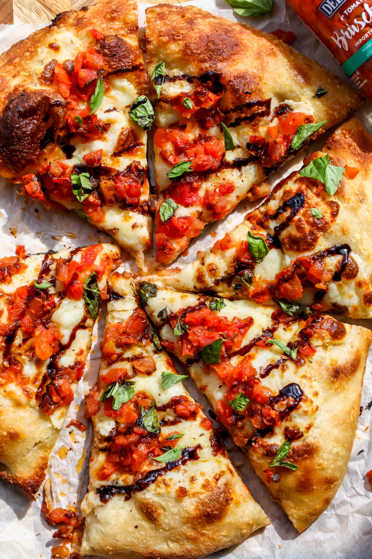 A sliced Bruschetta Pizza assembled on a cutting board.
