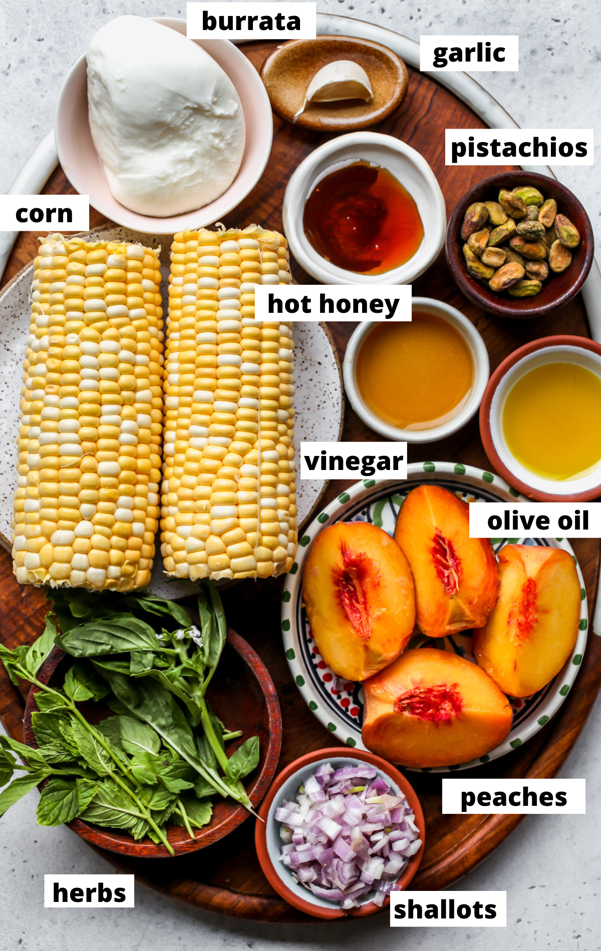 Recipe ingredients arranged on a wooden platter with labels.