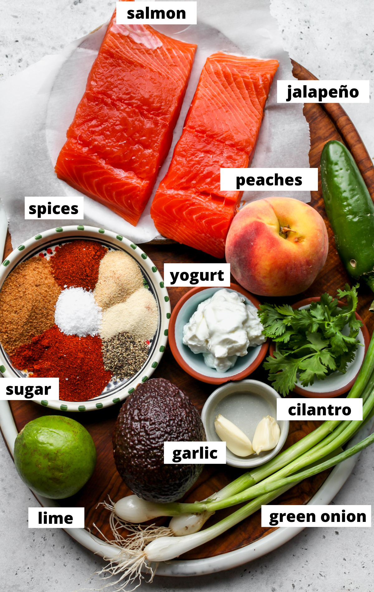 Recipe ingredients arranged on a wooden platter with labels.
