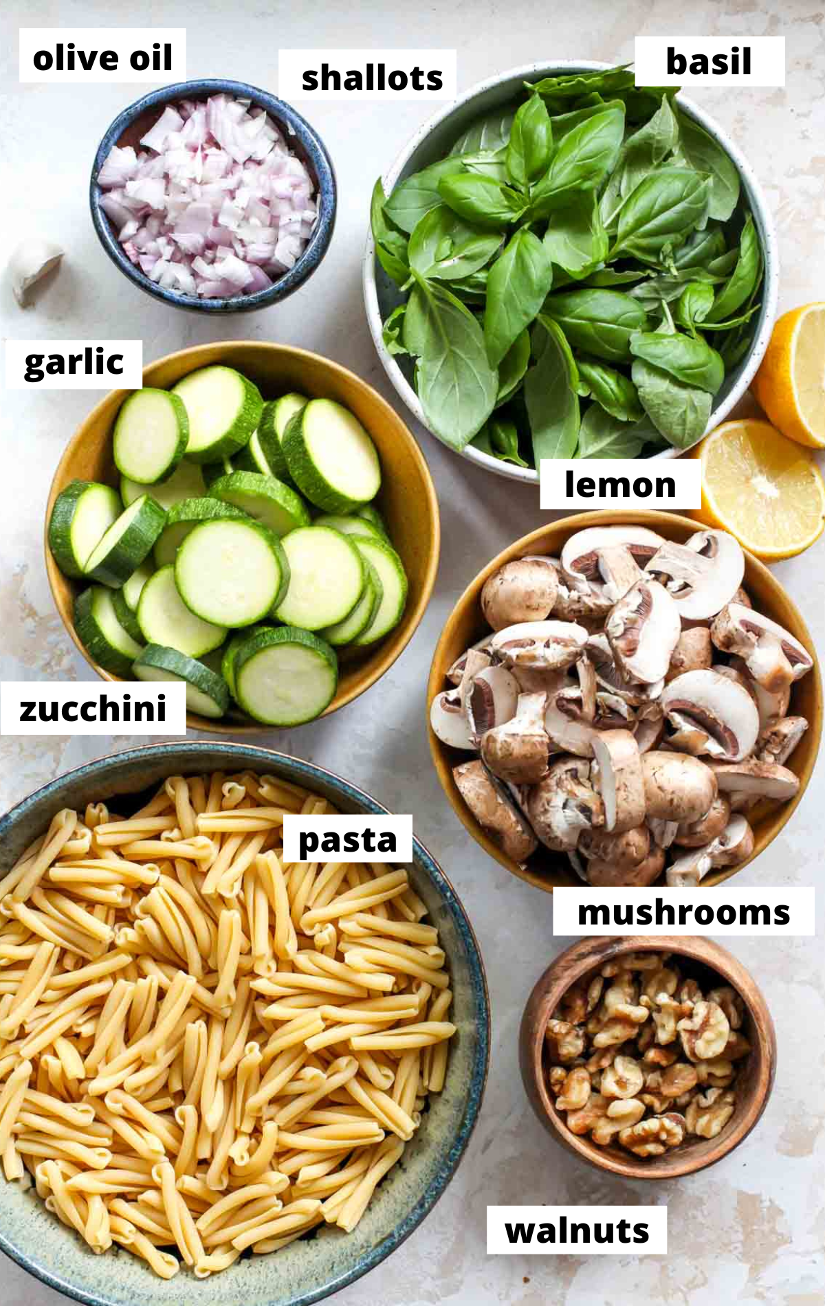 Recipe ingredients in separate bowls arranged on a work surface with labels.