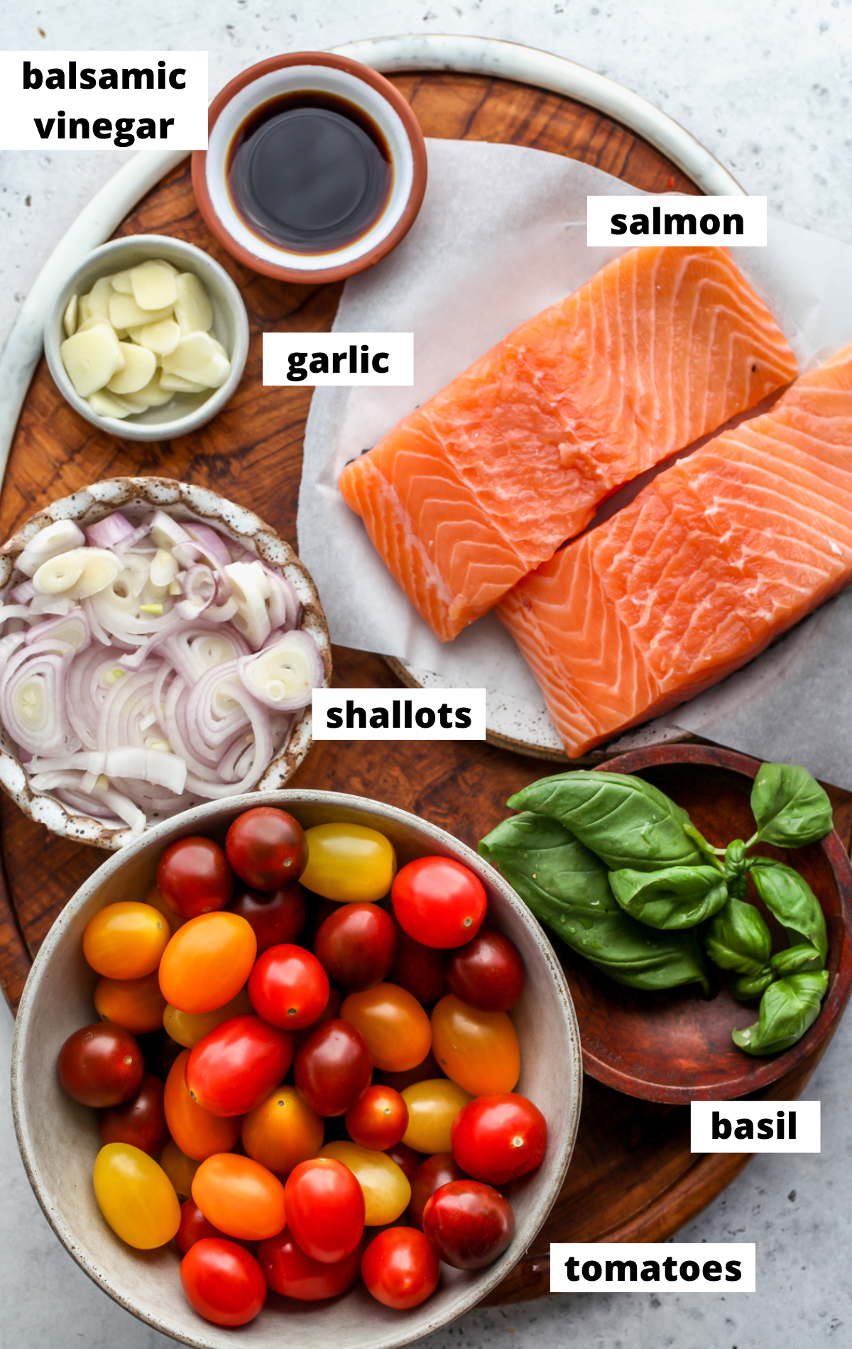Recipe ingredients arranged on a wooden platter with labels.