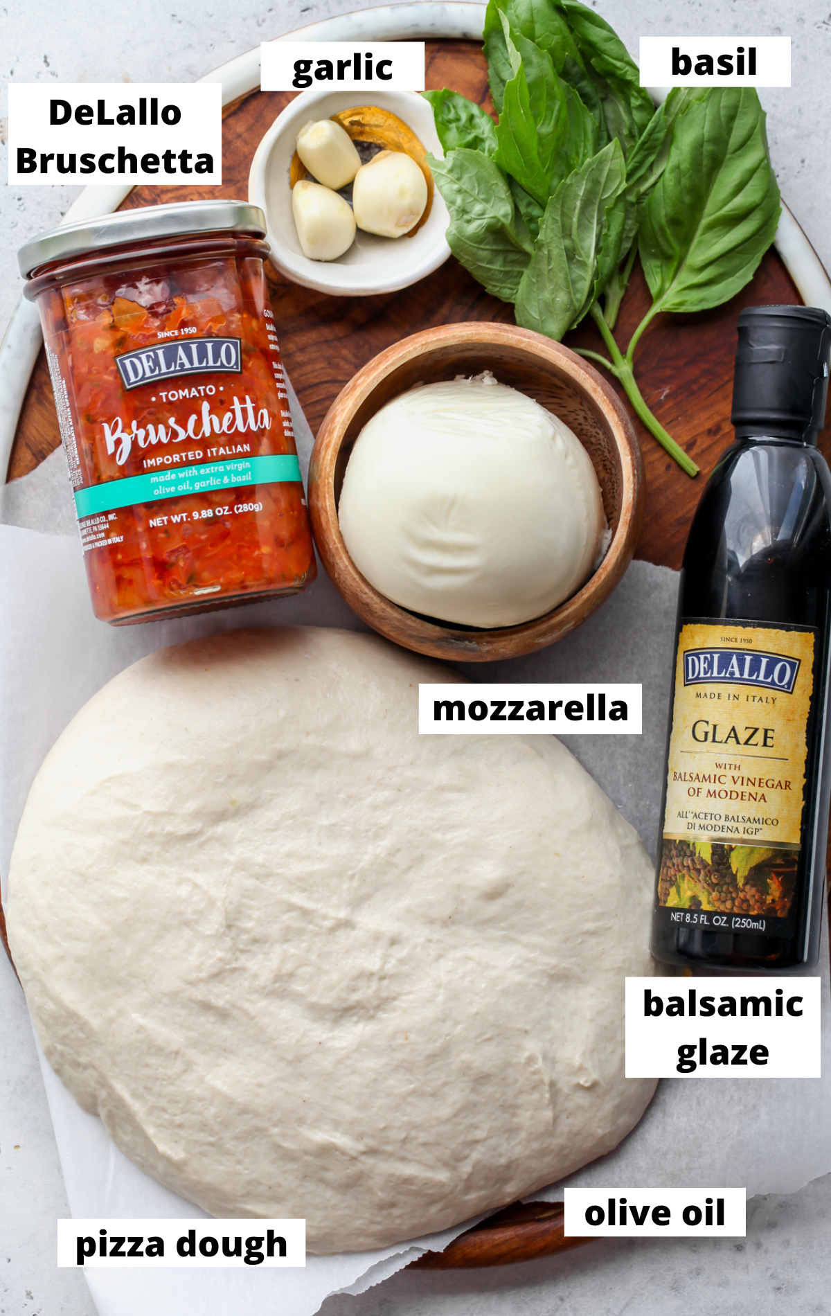 Recipe ingredients arranged on a wooden platter with labels.