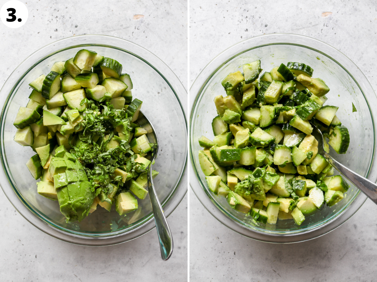 Cucumber-avocado salad being mixed in a large clear glass bowl.