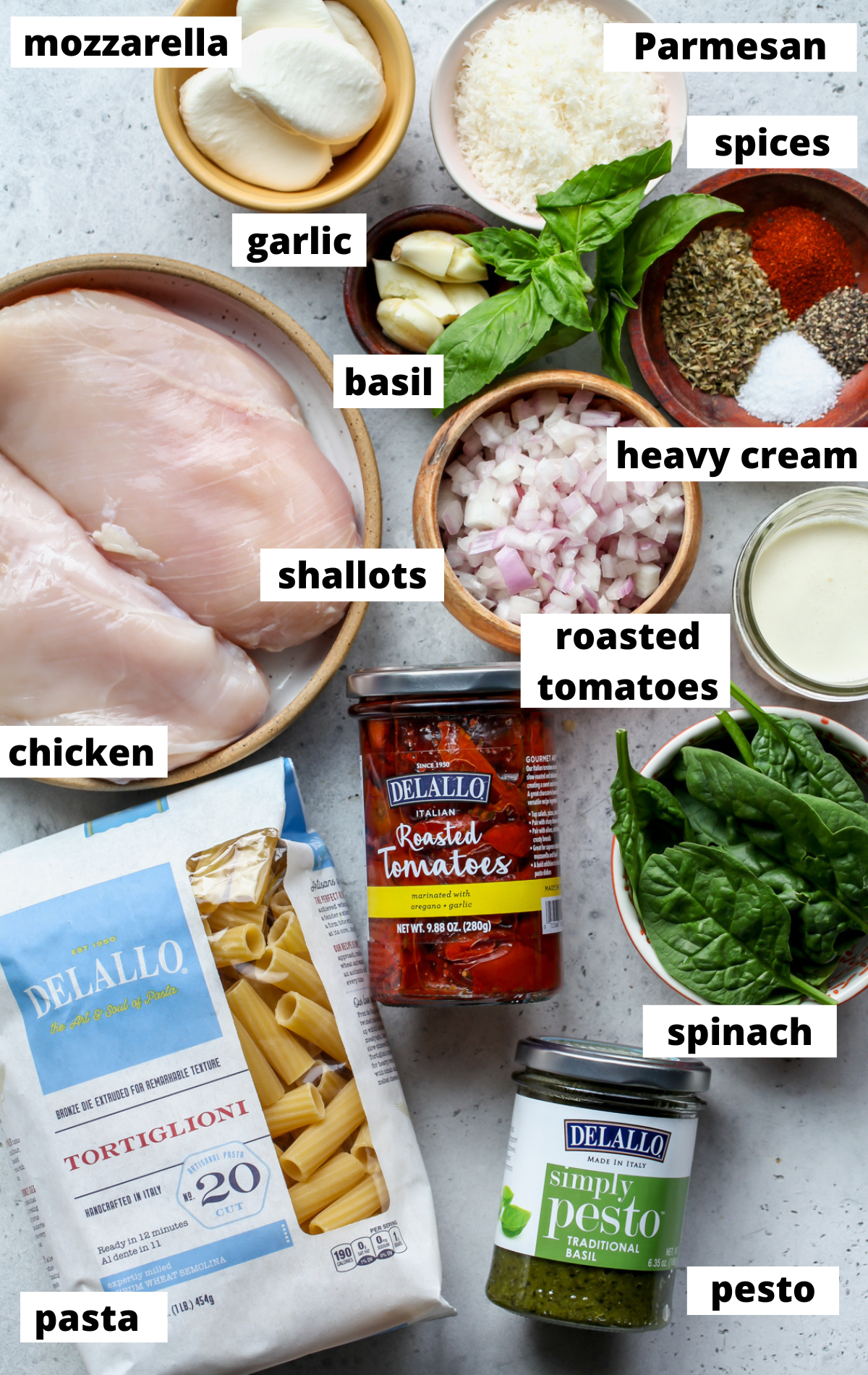 Recipe ingredients in separate bowls arranged on a wooden platter with labels.