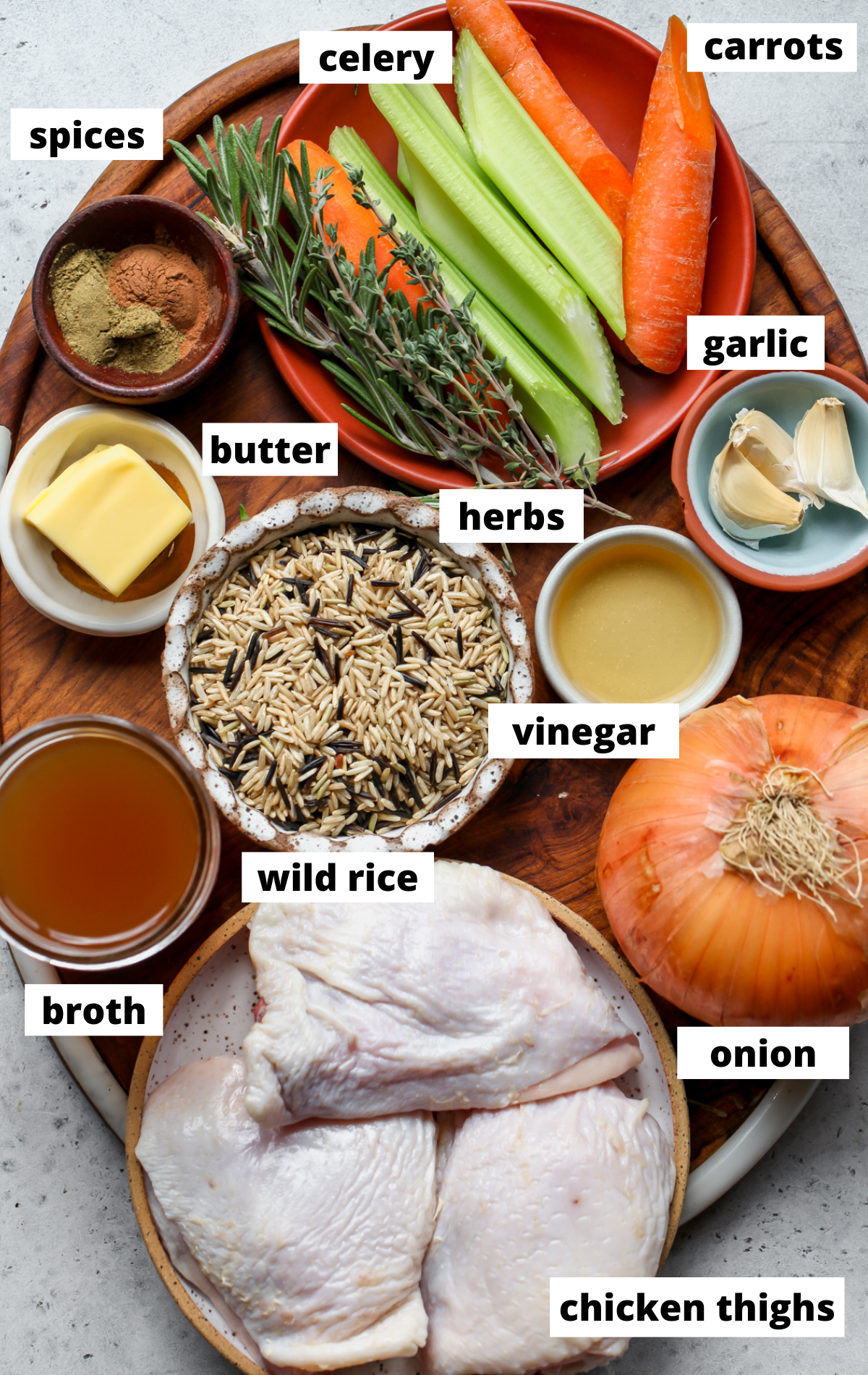 Recipe ingredients in separate bowls on a wooden board with labels.