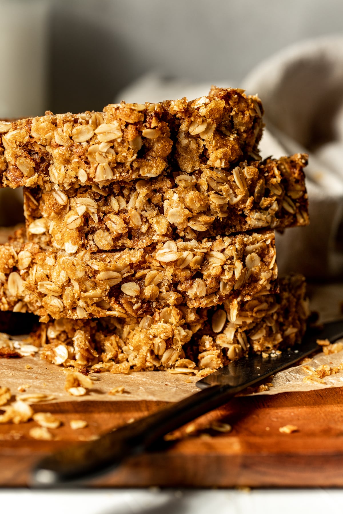 A stack of four slices of apple oatmeal bread arranged on a cutting board.