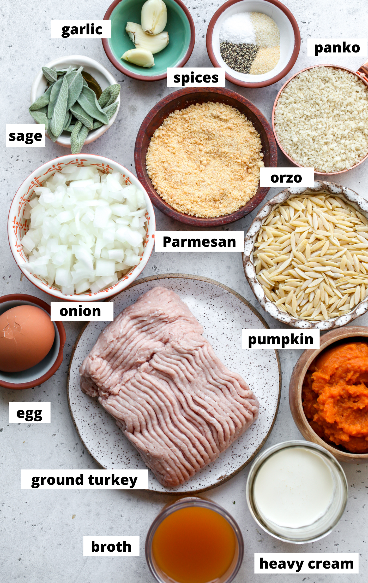 Recipe ingredients in separate bowls arranged on a wooden board with labels.