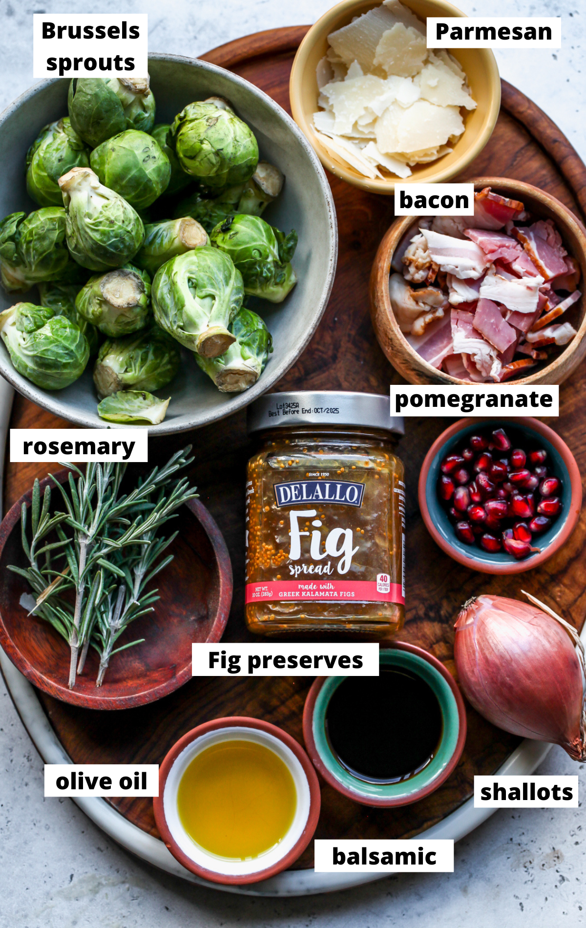 Recipe ingredients arranged in separate bowls on a wooden board with labels.