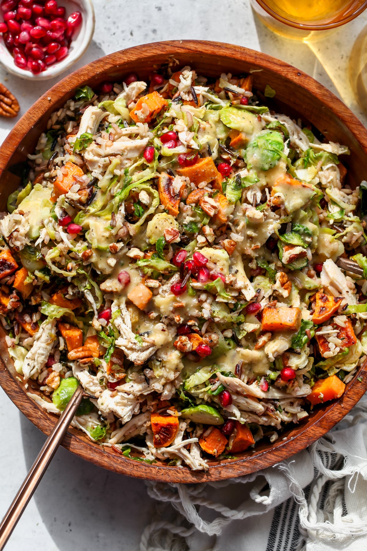 Harvest Fall Salad with shallot dressing styled in a large wooden serving bowl.