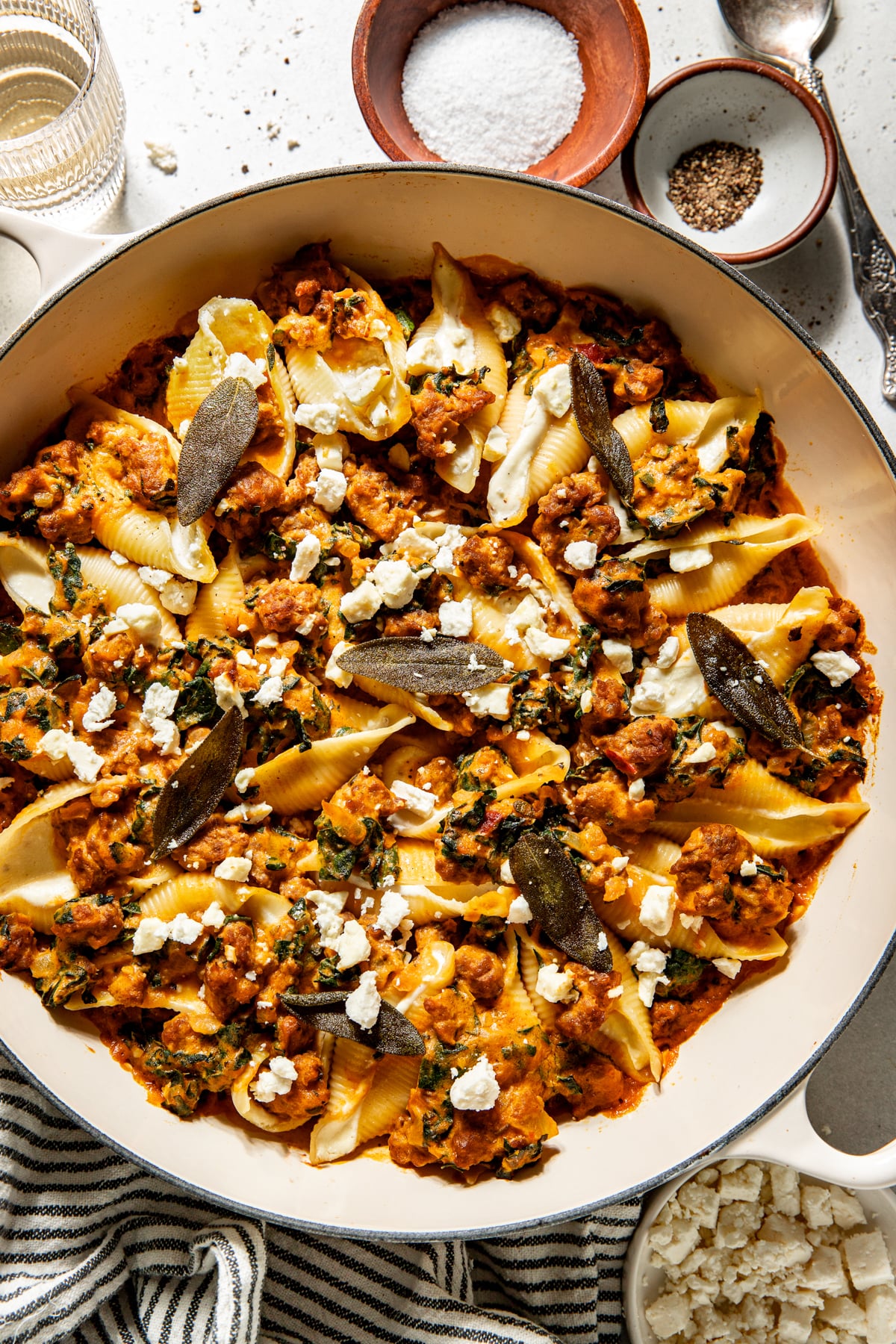 Pumpkin and feta stuffed shells styled in a white pan.