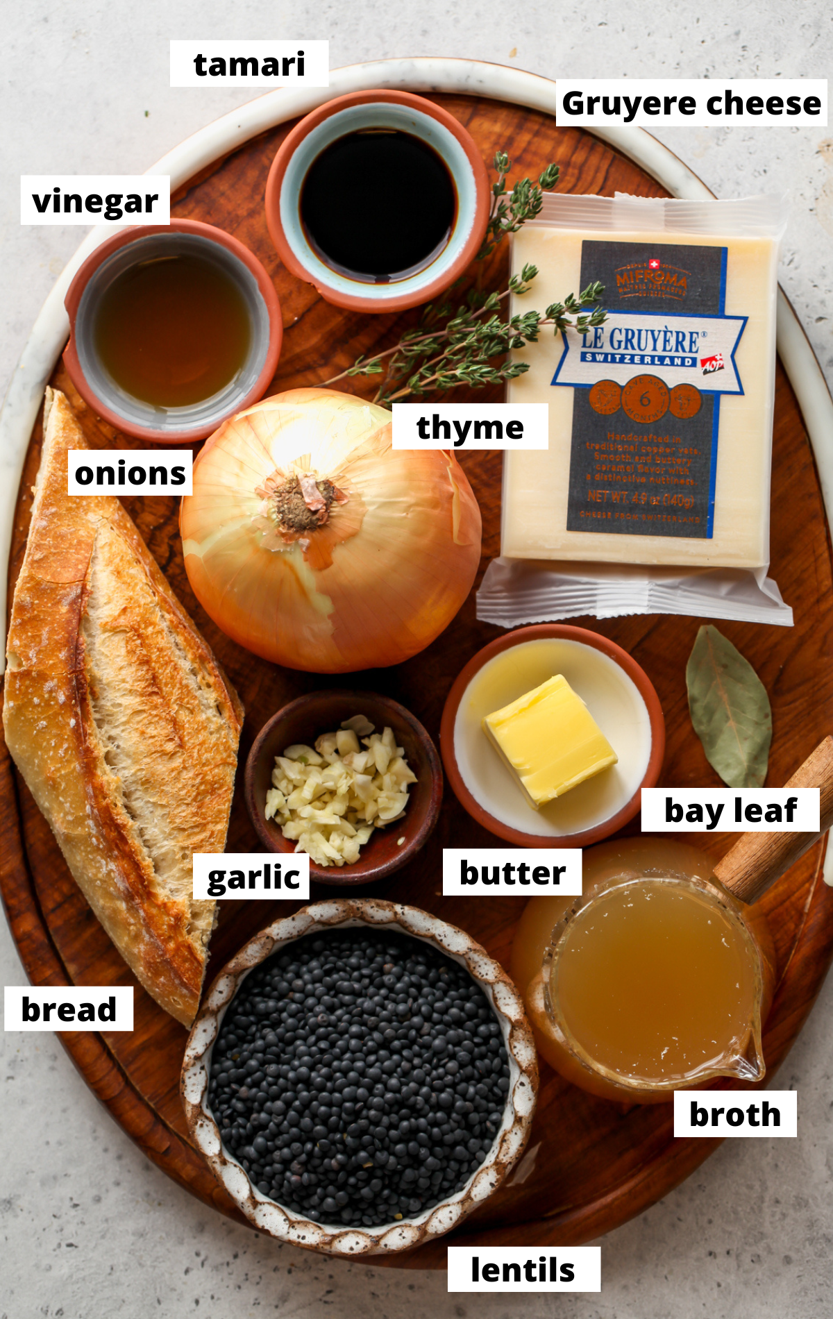 Recipe ingredients arranged on a wooden platter with labels.