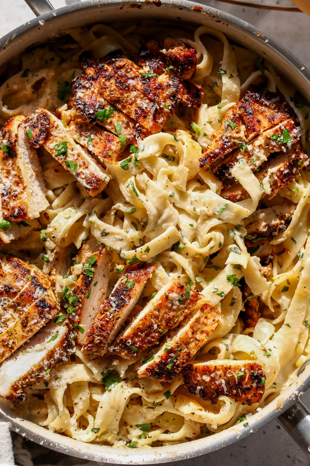 Creamy Lemon Chicken Pasta tossed in a saute pan.