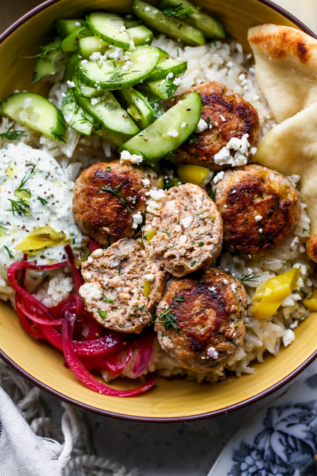 A turkey meatball being sliced into to show inside texture.