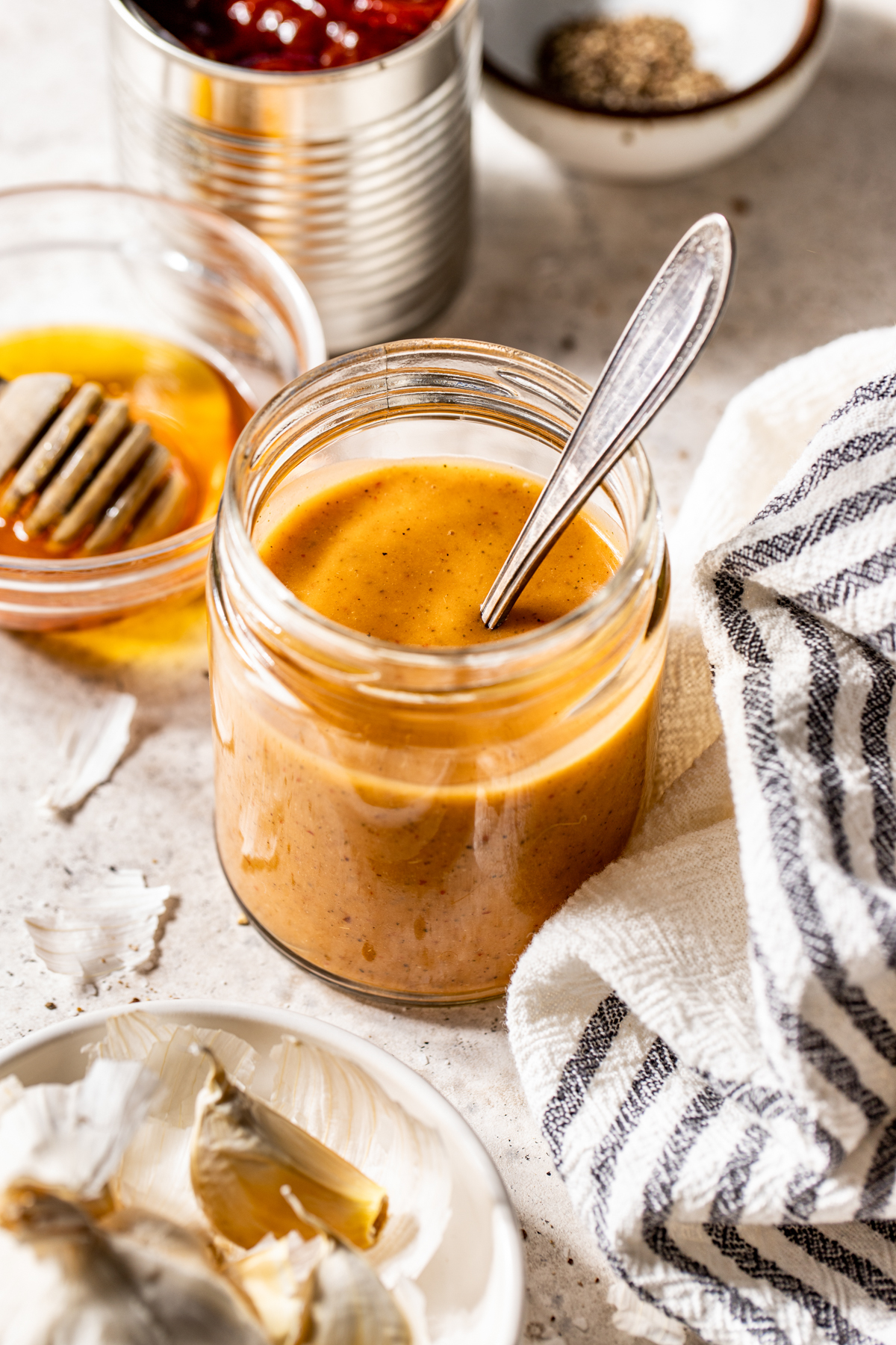 Homemade Chipotle Vinaigrette styled in a glass jar on a light work surface.