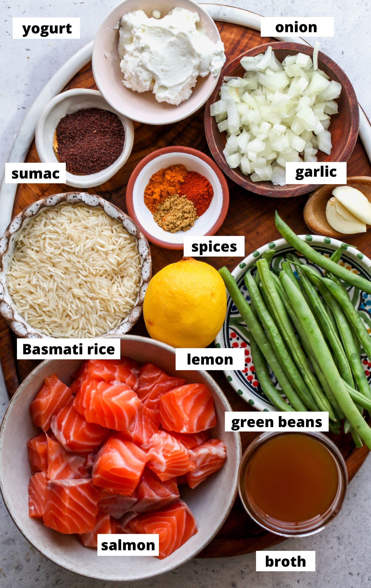 Recipe ingredients arranged in separate bowls on a wooden surface.