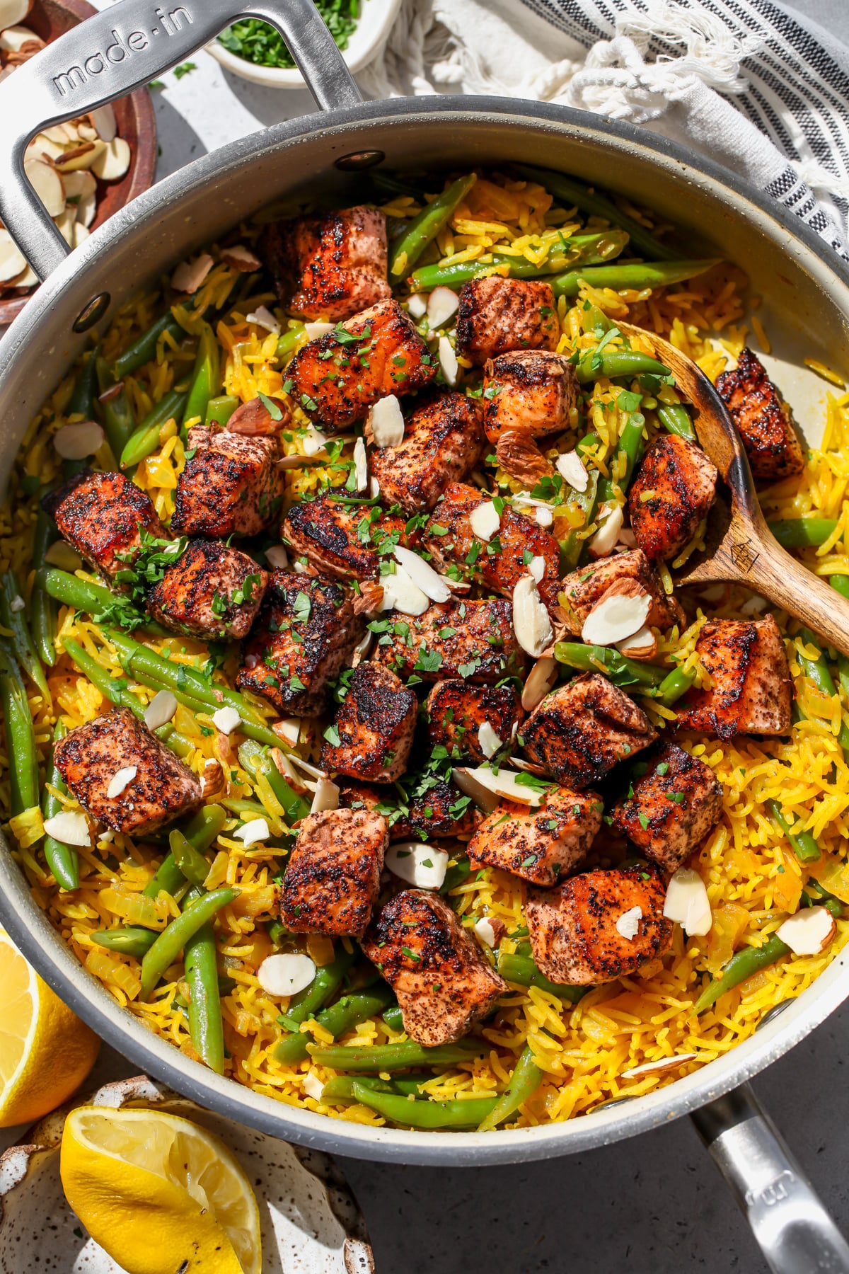 Sumac Salmon with golden rice and green beans styled in a sauté pan.