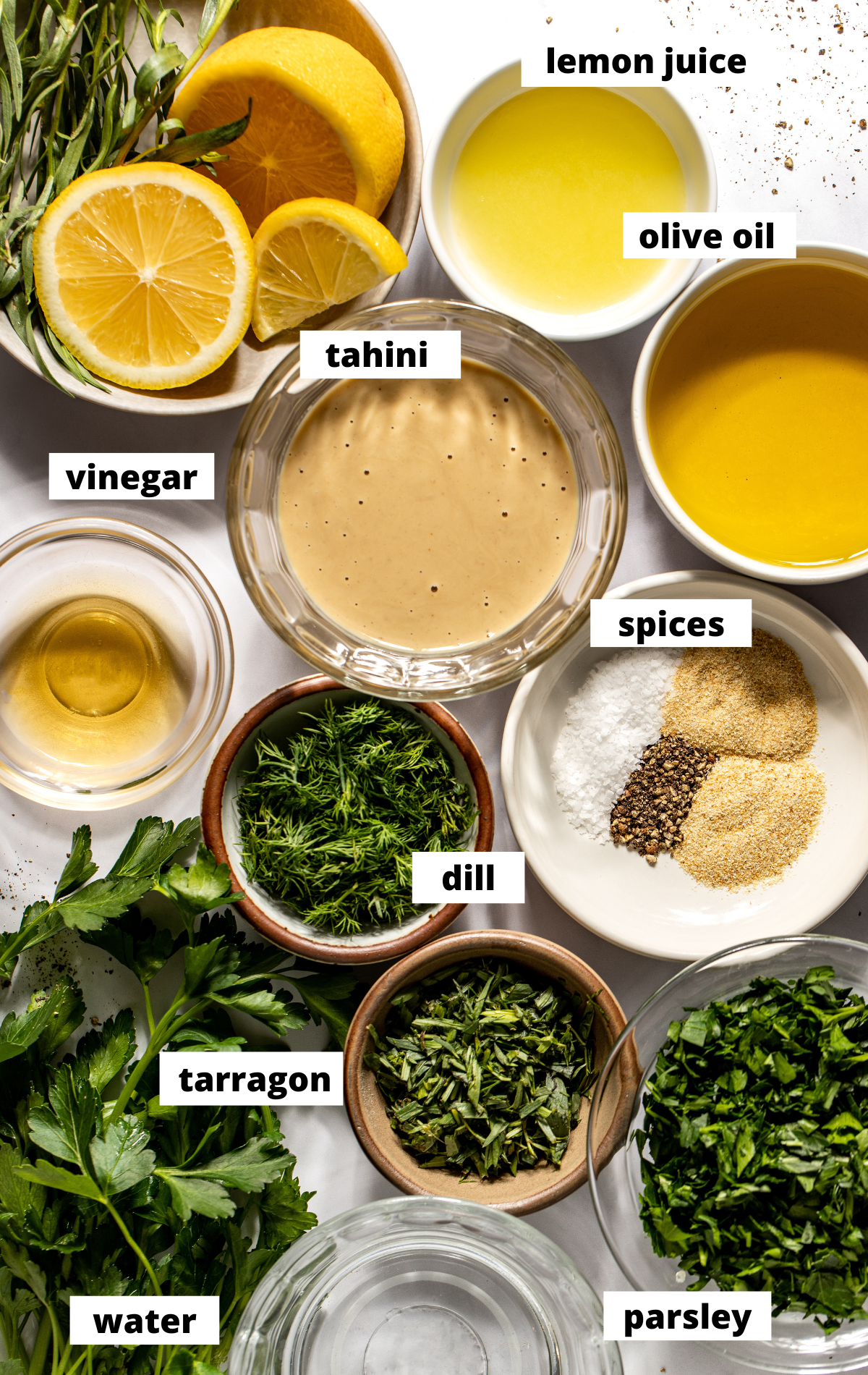 Recipe ingredients in separate bowls arranged on a white surface with labels.