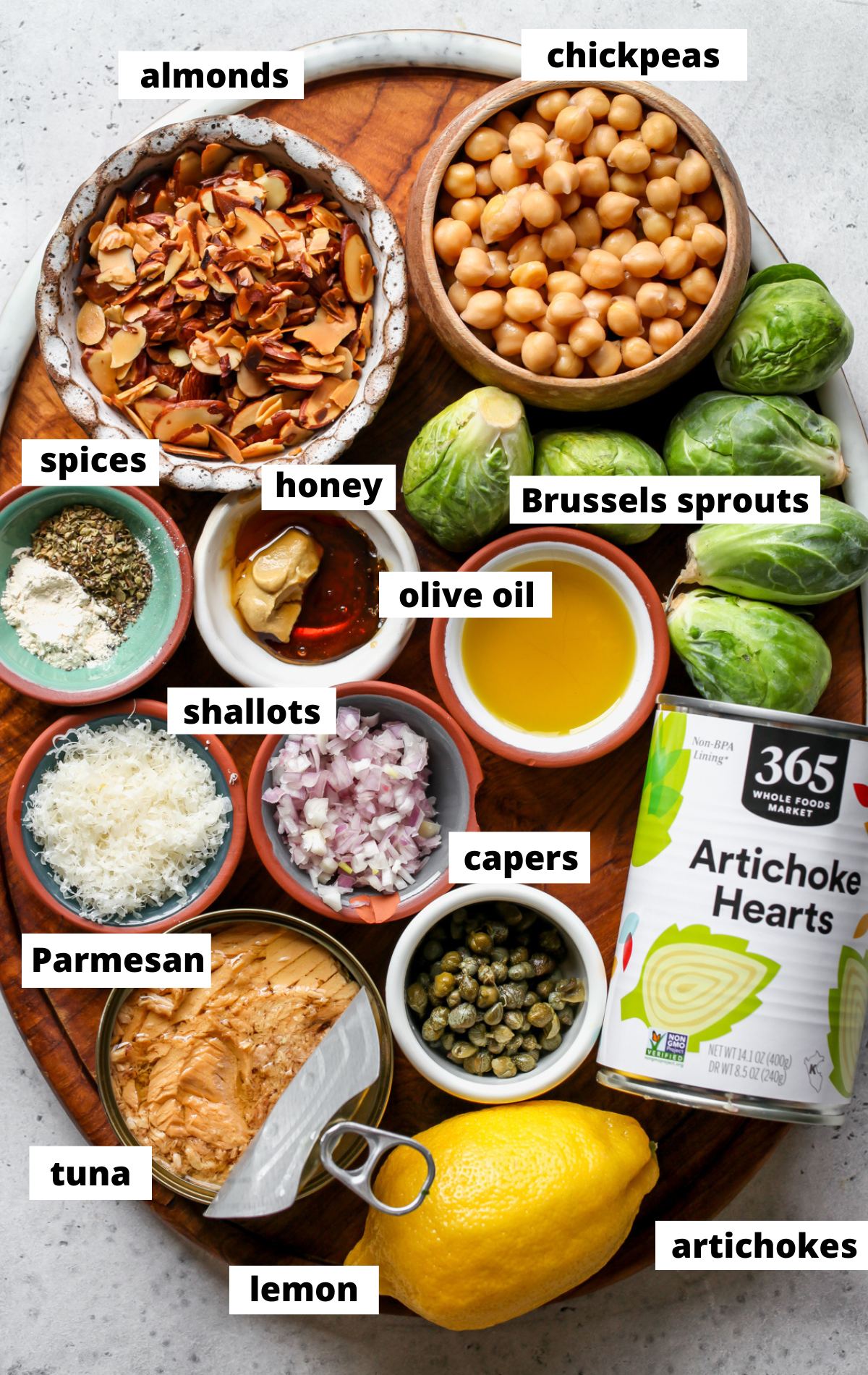 Recipe ingredients arranged on a wooden board with labels.