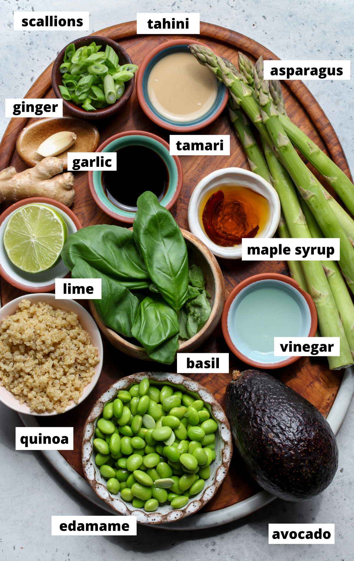 Recipe ingredients in separate bowls arranged on a wooden board with labels.