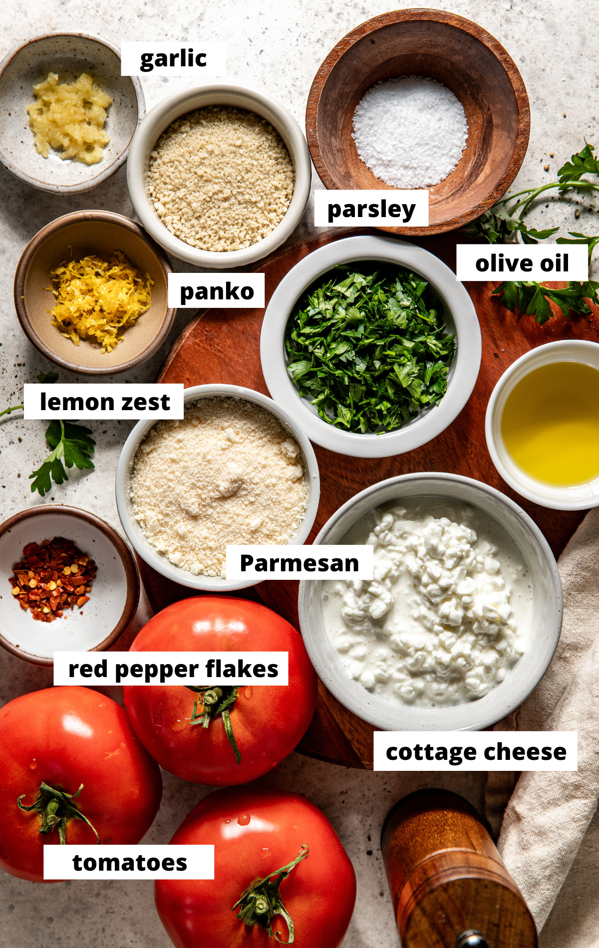 Recipe ingredients in separate bowls arranged on a white surface with labels.