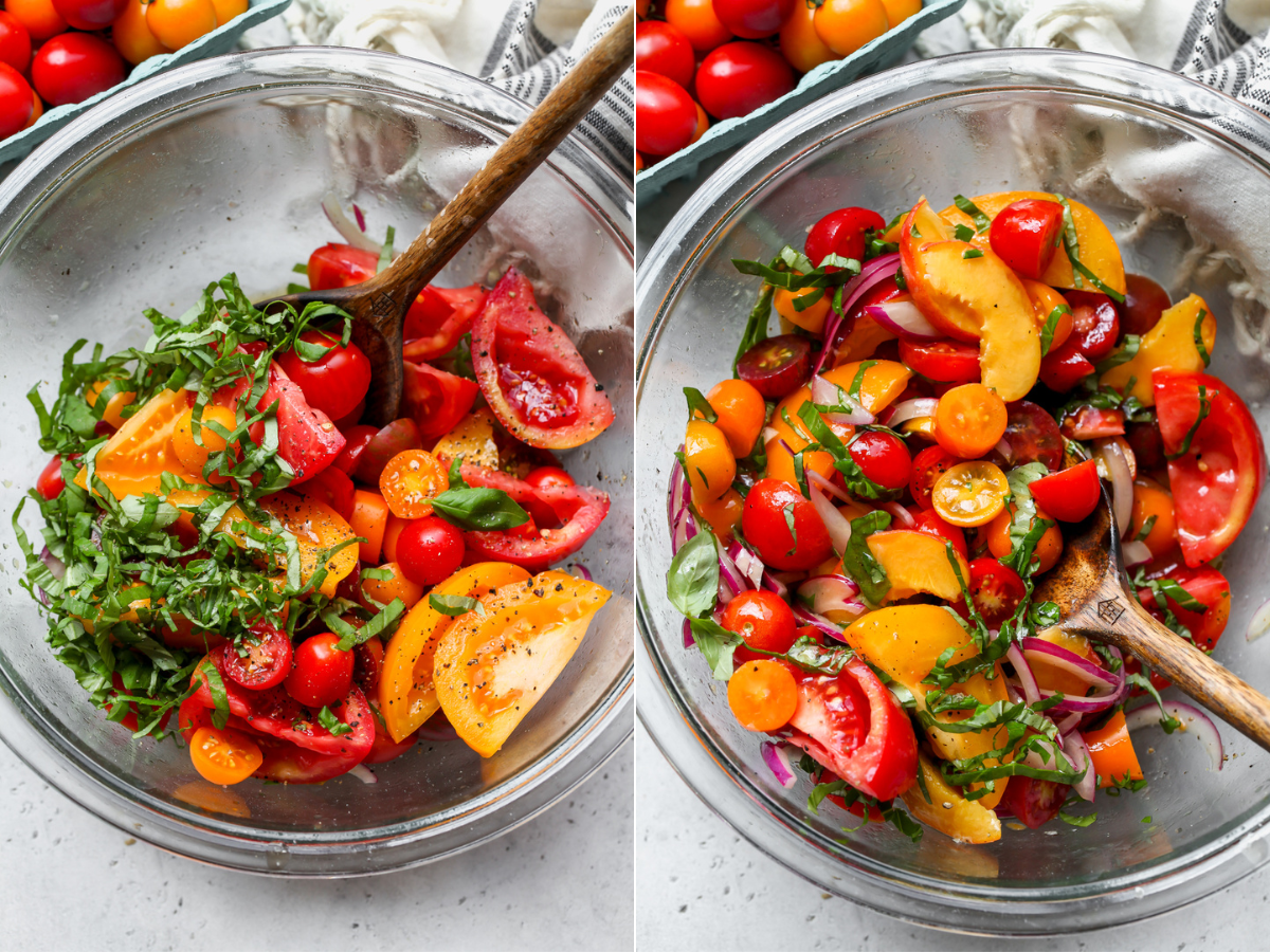 Tomatoes, peaches, and basil being tossed in dressing in a large clear glass mixing bowl.