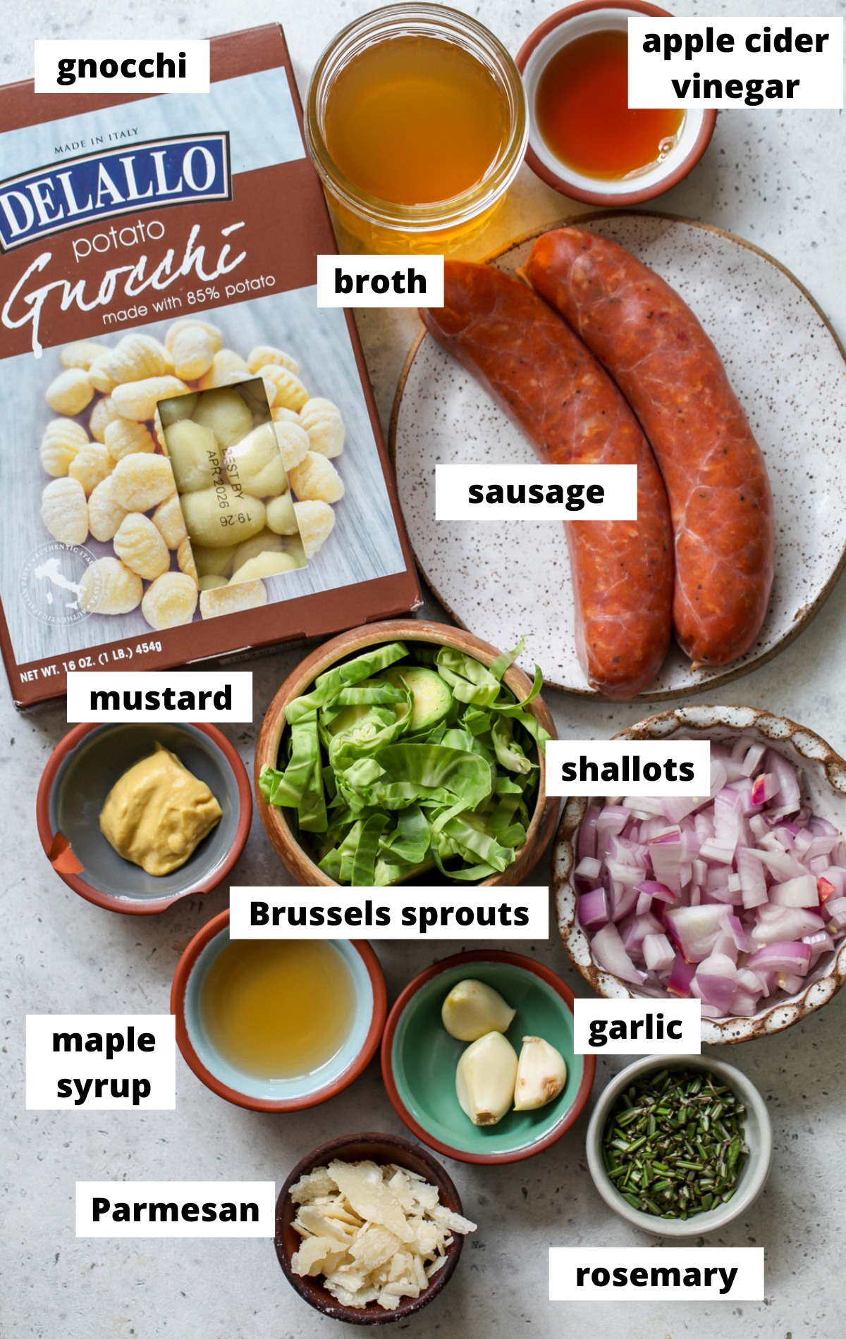 Recipe ingredients in separate bowls arranged on a wooden tray with labels.