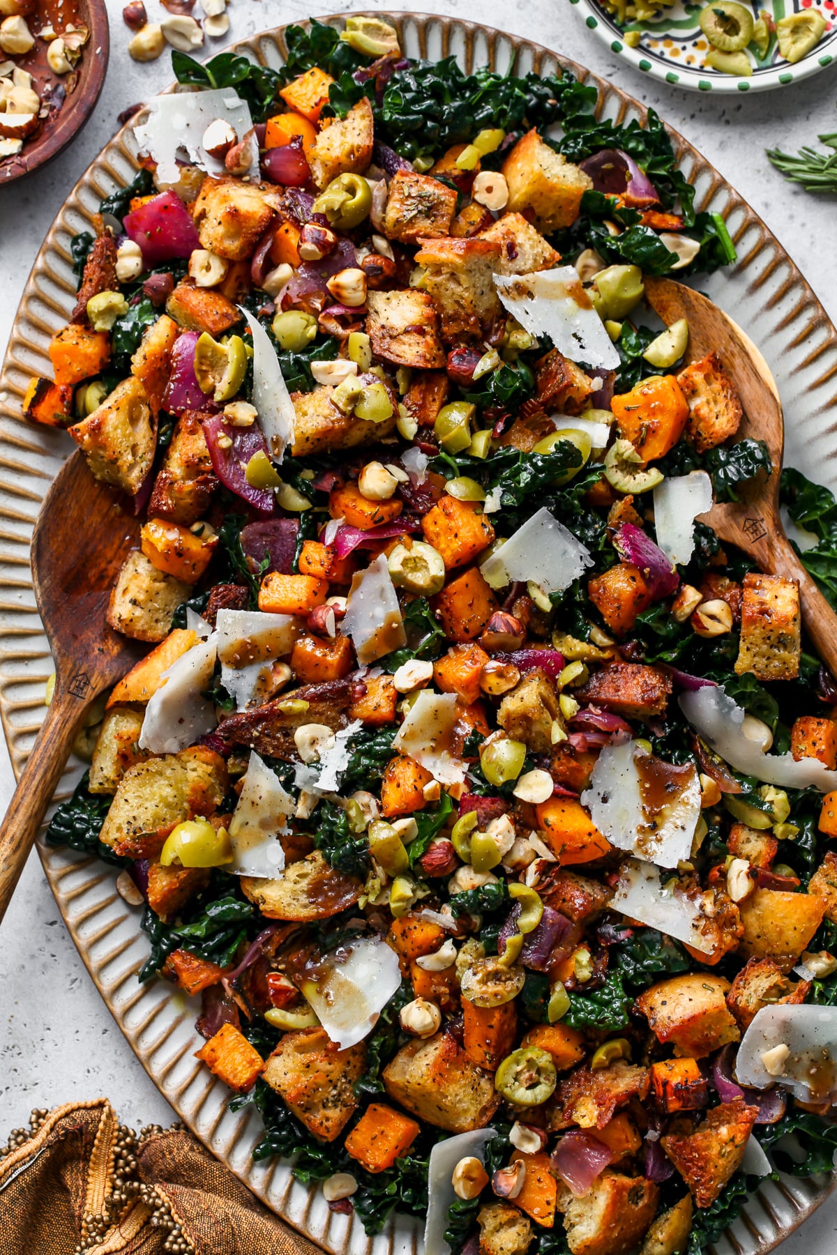 Autumn Panzanella Salad styled on a large light blue scalloped serving platter.