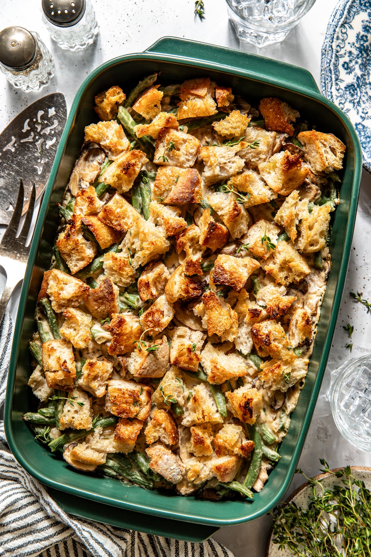 Vegan green bean casserole after being baked in a green baking dish.
