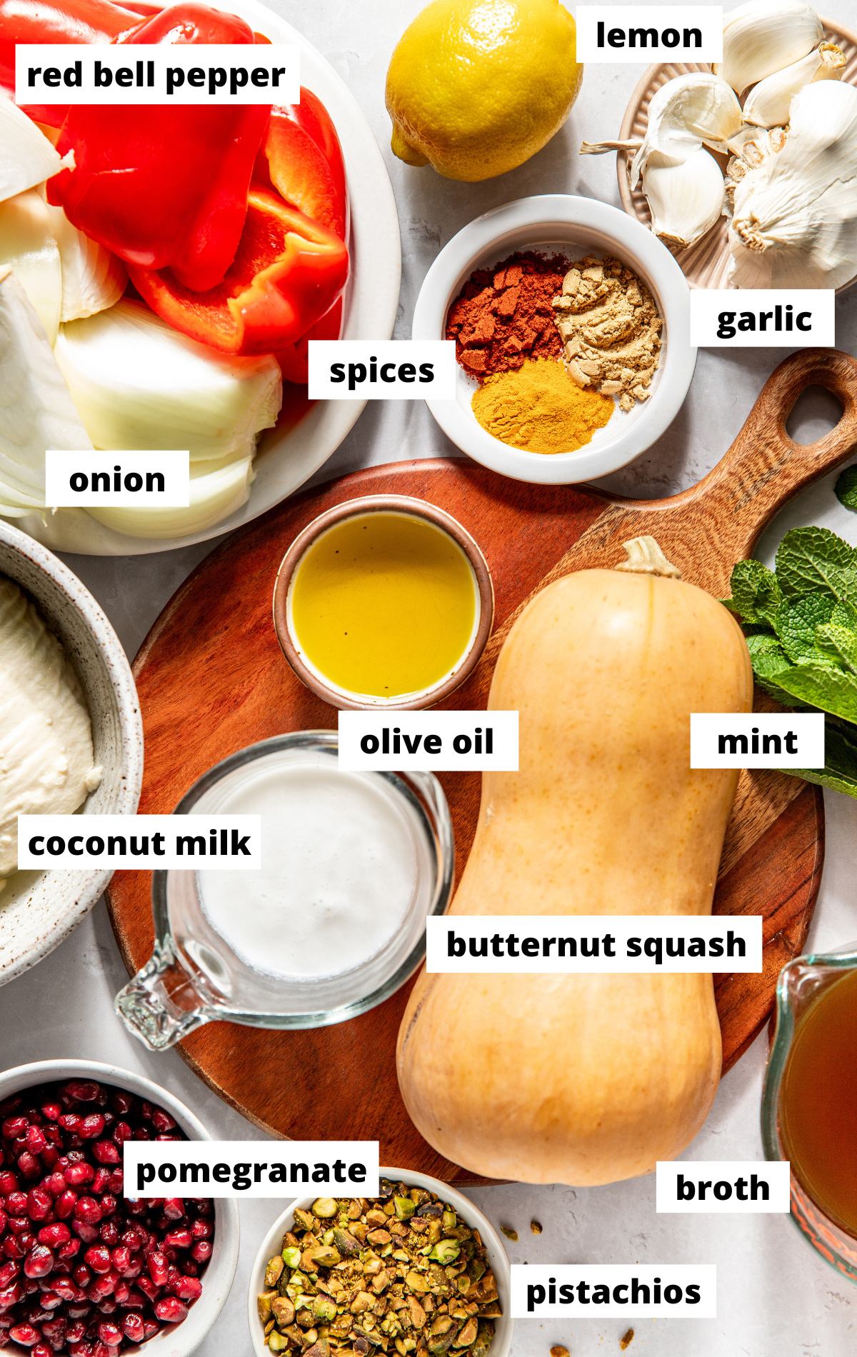 Recipe ingredients in separate bowls arranged on a white surface with labels.