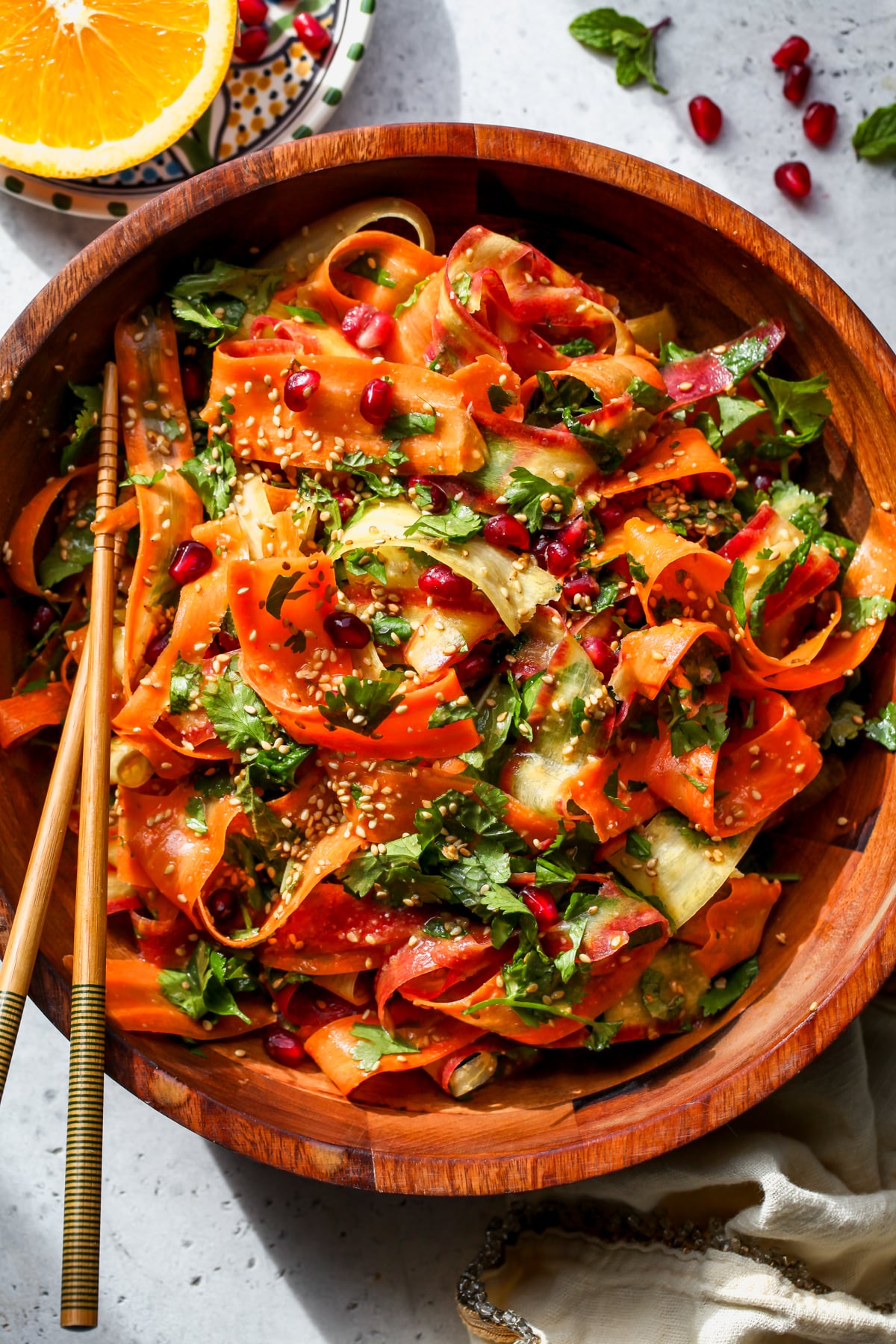 Shaved Carrot Salad with Citrus Miso-Ginger Dressing styled in a wooden serving bowl.