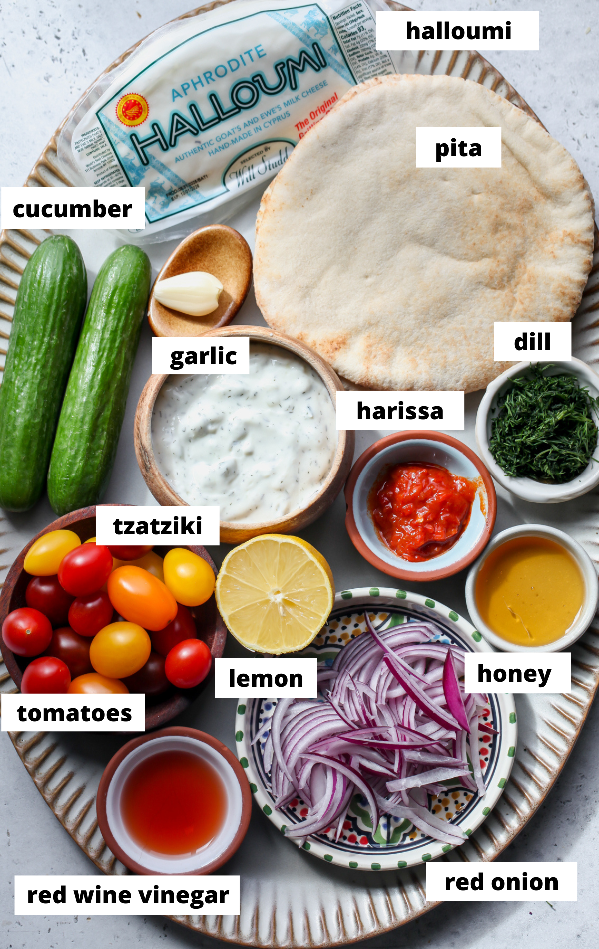 Recipe ingredients in separate bowls arranged on a large platter with labels.
