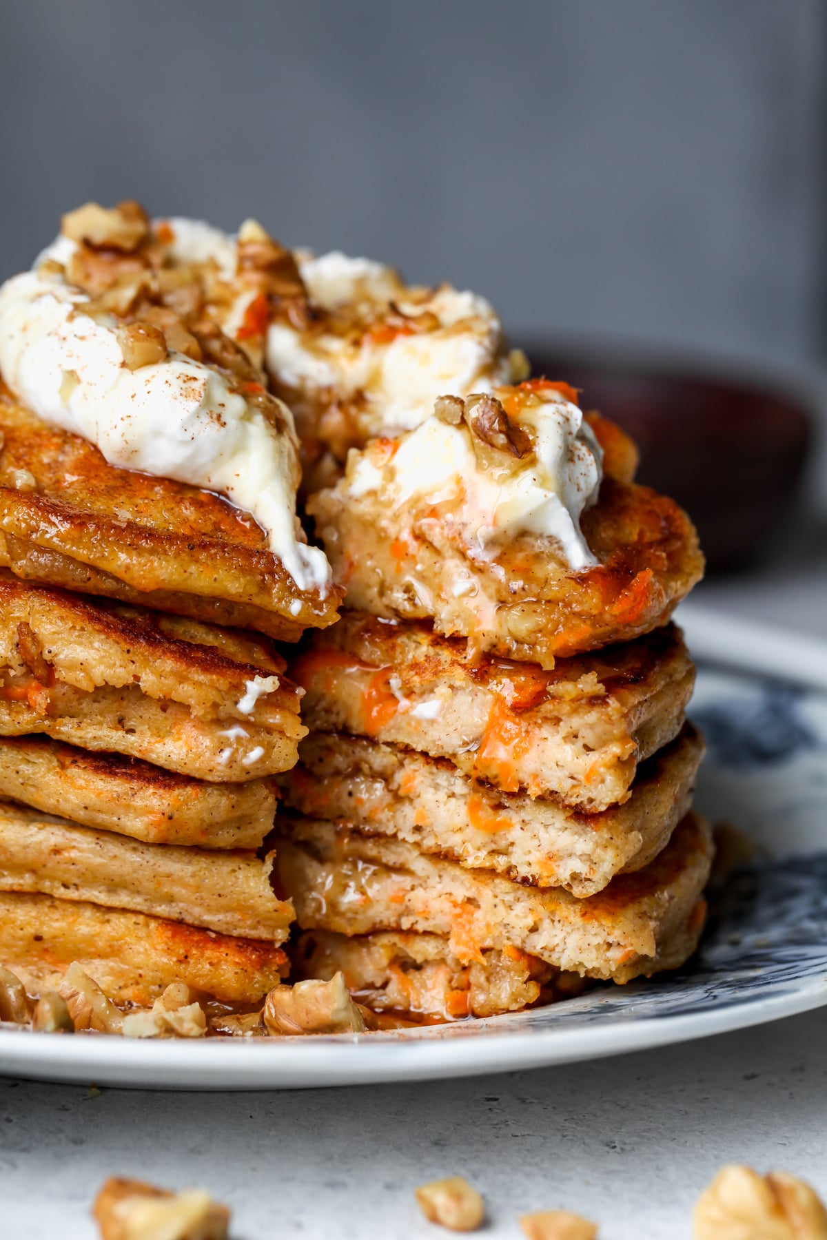 A stack of healthy carrot cake pancakes sliced into to show the inside texture.