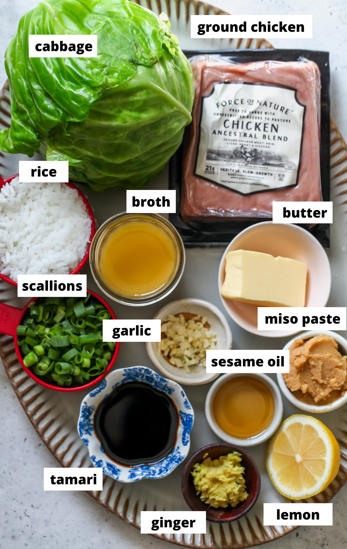 Recipe ingredients arranged on a large platter with labels.